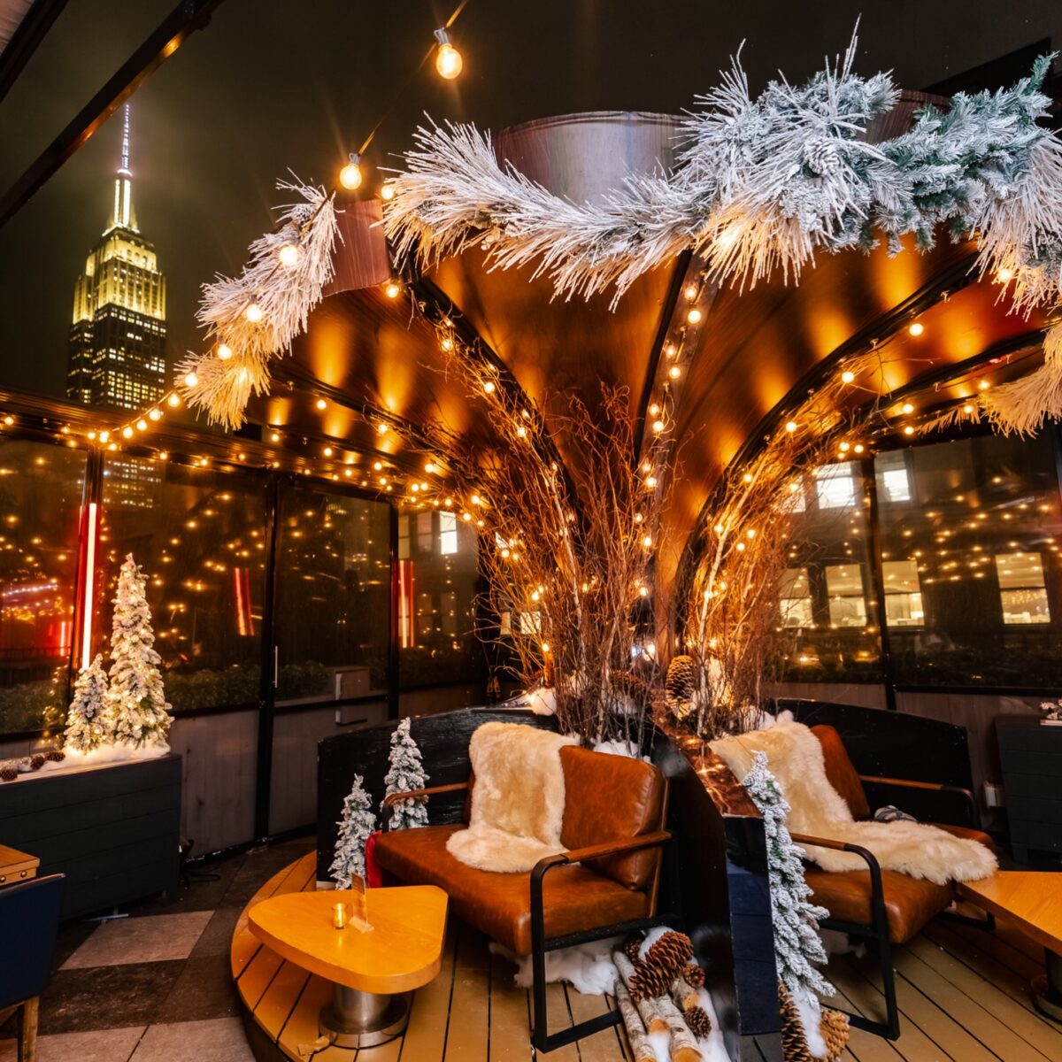 Faux log cabin wall fabrication around dining tables on the Magic Hour rooftop