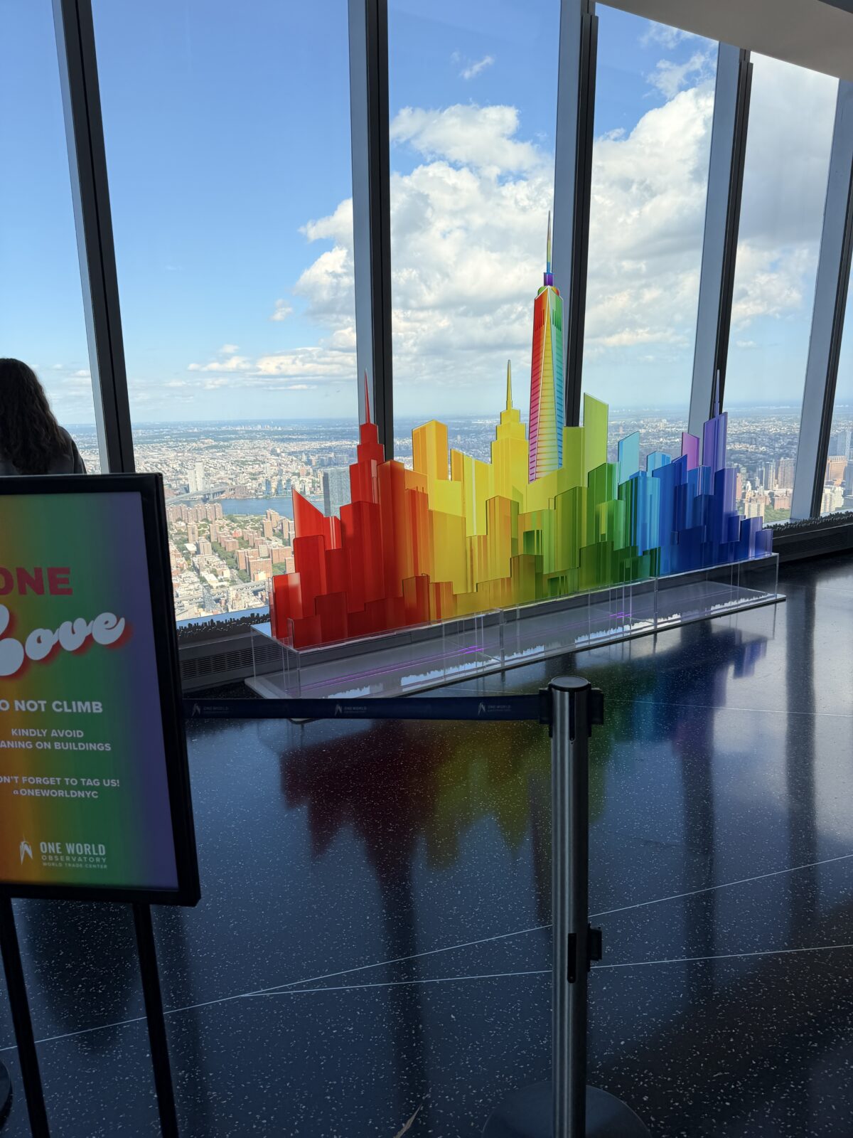 Visitors photographing the One Love Pride installation 1,250 feet above Manhattan